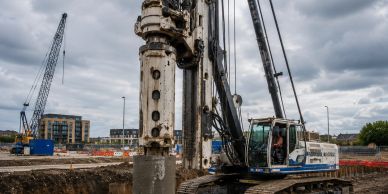 Heavy machinery drilling at a construction site.