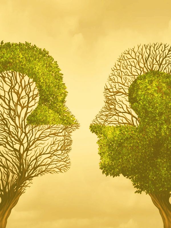 Two trees shaped like two heads and part of a jigsaw symbolising the connectivity of therapy.