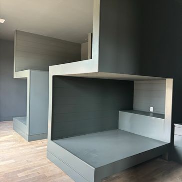 Modern built-in bunk beds with a minimalist design.
