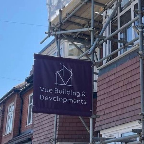 Sign for Vue Building &amp; Developments on scaffolding outside a building.