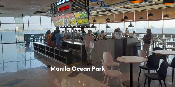 Indoor dining area with ocean view at Manila Ocean Park.