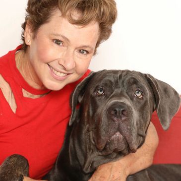 Smiling woman with a large gray dog.