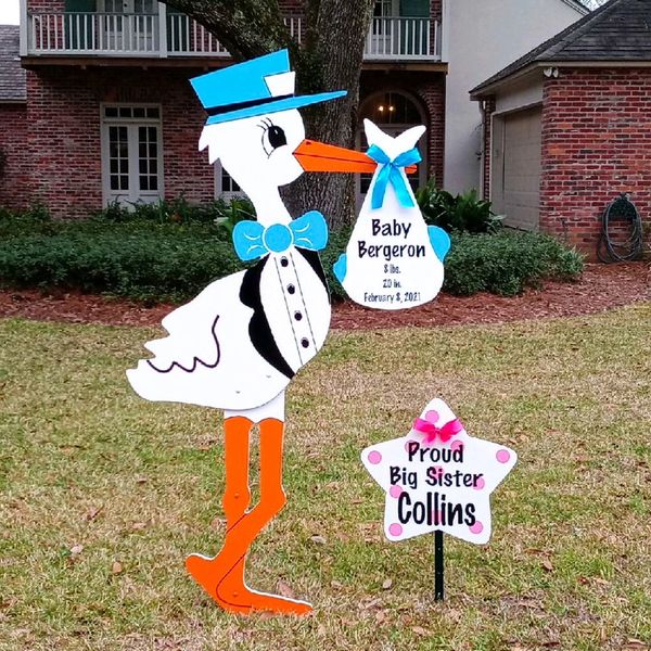 Stork yard sign.  Stork hold a bundle with new babies name and birth stats. 