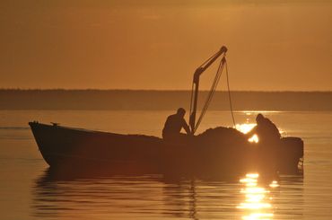 Christopher LeClaire Photography. Golden sunrise on boat. Cape Cod sunrise on Chatham Mass boat.