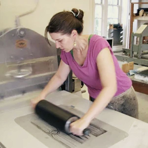 Photograph of Sara Parkel printing lithography. 