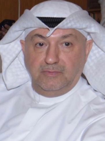 Portrait of a middle-aged man in traditional Middle Eastern attire.