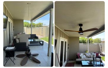 Cozy outdoor patio with seating and a ceiling fan.