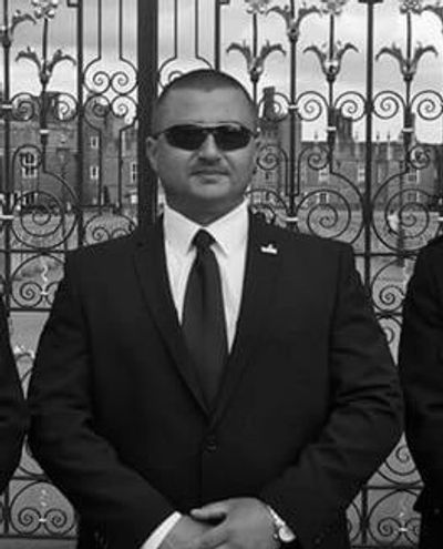 Alin Musat a Close protection operative in a dark suit. 