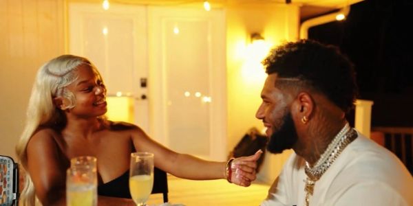 Couple sharing a joyful moment at an outdoor dinner.