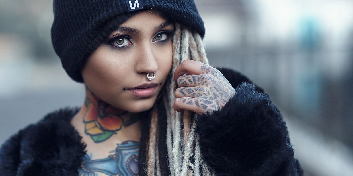 Girl with nose ring and dahlia piercings with beanie