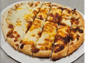 Cheesy pizza with thick crust, cut into strips.