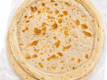 Packaged pizza crusts in plastic wrap.