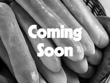 Fresh breadsticks in a basket with 'Coming Soon' text.
