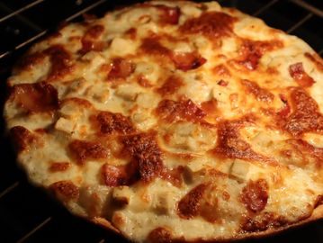 Close-up of a cheesy pizza with toppings.