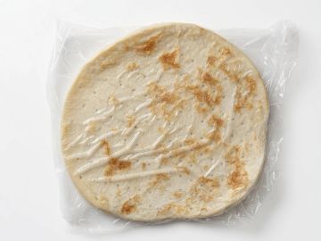 A flatbread wrapped in clear plastic.