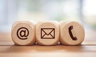 Wooden blocks with email, letter, and phone icons.