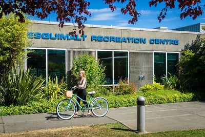 Person with bike outside Esquimalt Recreation Centre.