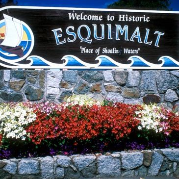 Welcome sign for Historic Esquimalt with colorful flowers.