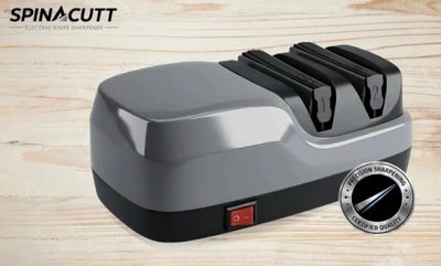 Electric knife sharpener with dual slots and power switch on wooden surface.