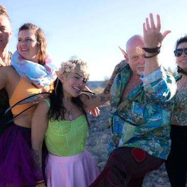 Group of friends in colorful costumes enjoying outdoors.