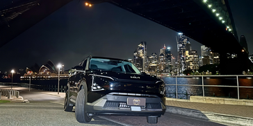 Mobile window tinting Sydney – tinted Kia EV5 near Sydney Harbour Bridge and Opera House.
