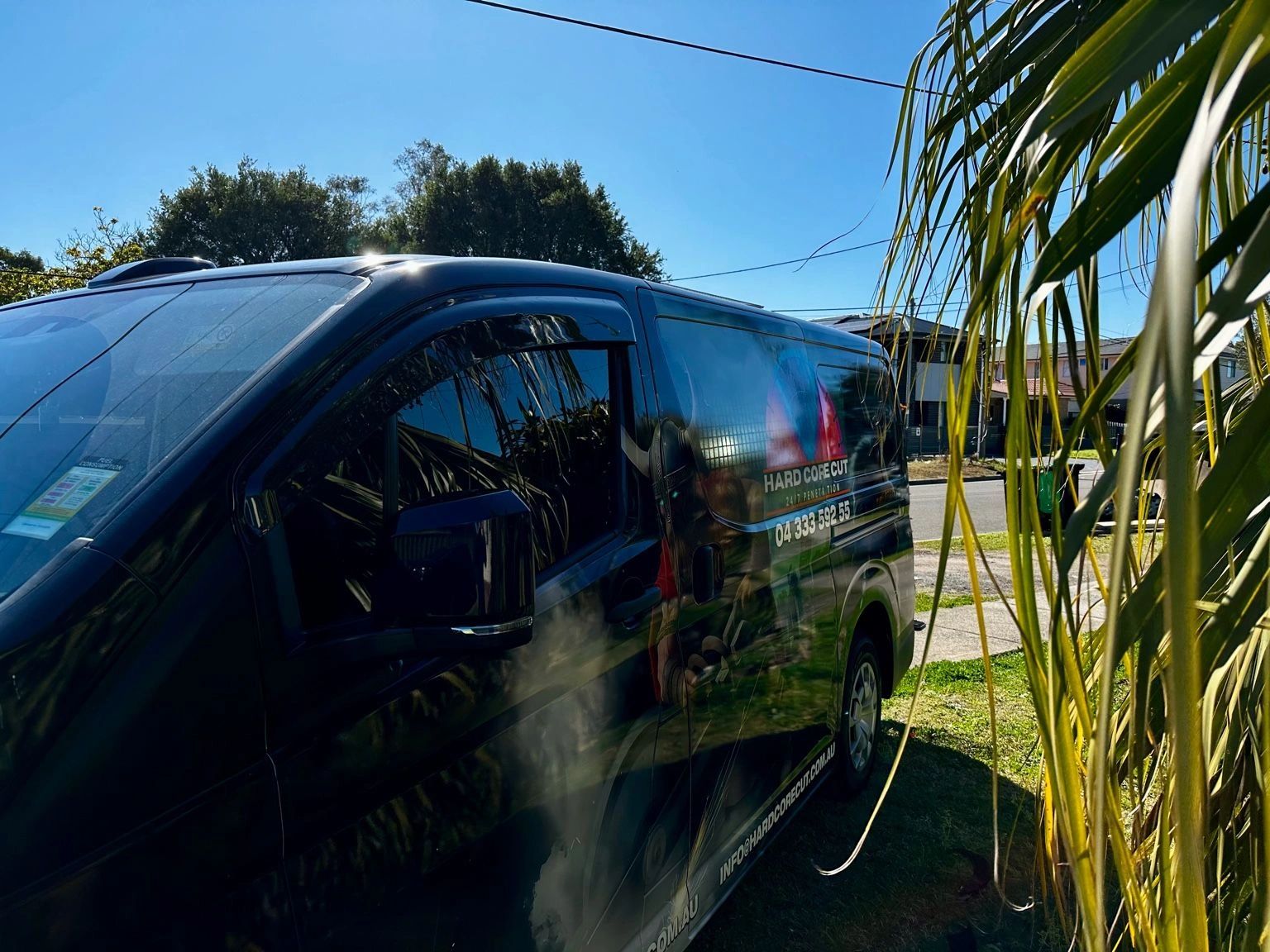 Toyota HiAce van front angled view with tinted windows