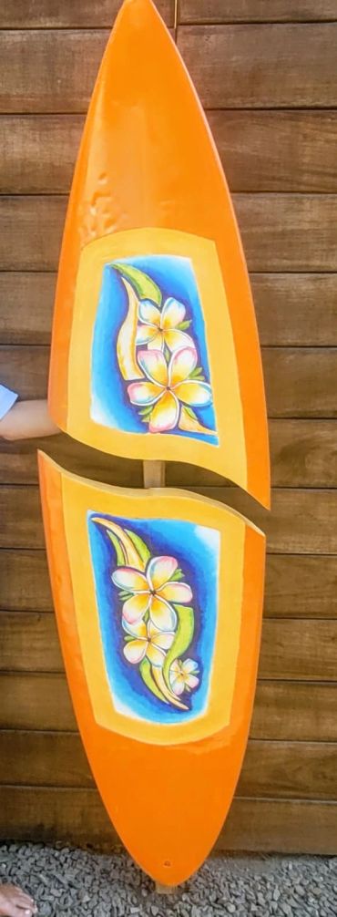 Colorful art on an orange wooden sculpture.
