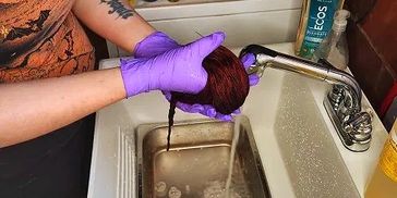 Washing hand dyed merino wool yarn.
