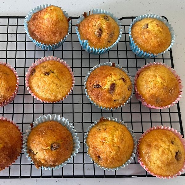 Freshly baked muffins cooling on a rack.