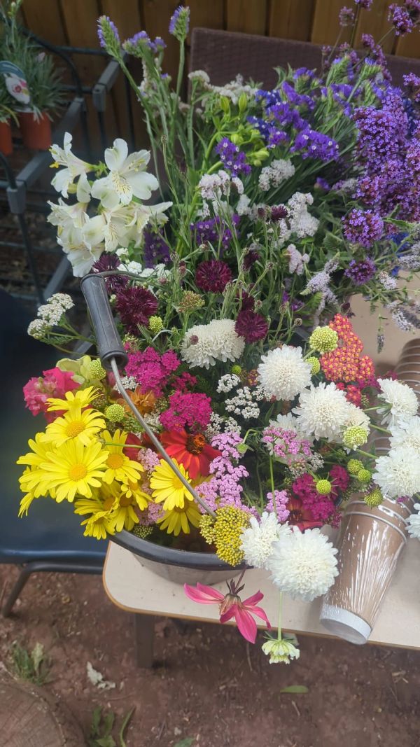 Colorful wildflower bouquet in a bowl on a table.