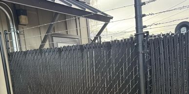Chain-link fencing with barbed wire security and gate with wheels