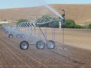 Pivot line with end spray gun and drop hose sprinkler