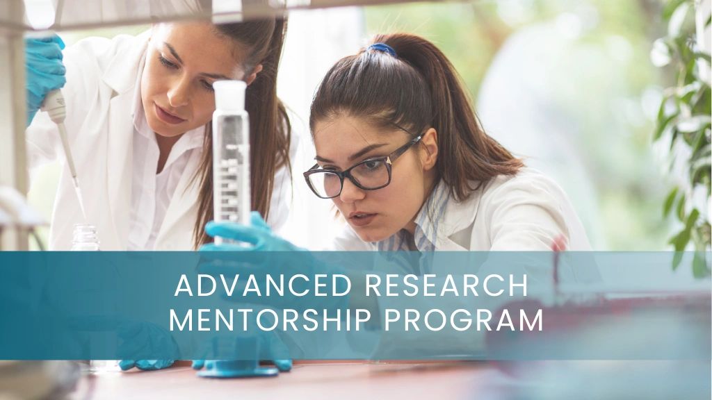 Two female scientists working with lab equipment in a mentorship program.