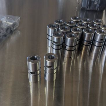 Metal mechanical parts arranged on a reflective surface.