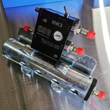 Industrial pneumatic device with pressure gauge and valves.