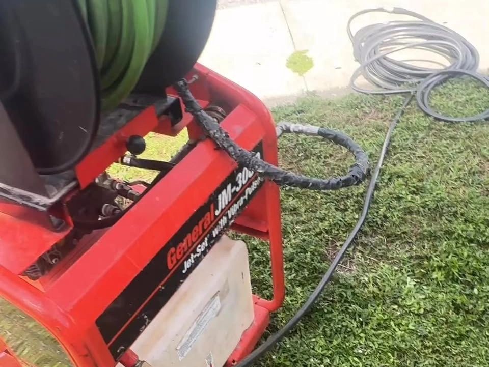 Hydro jetting machine and hose at a Hurricane Plumbing project.