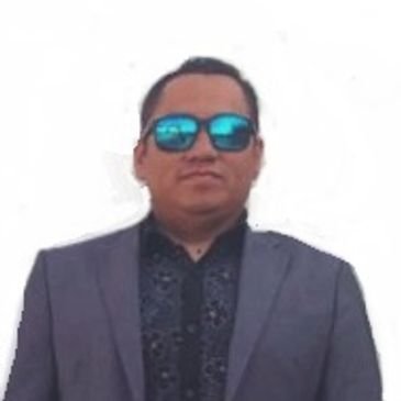 Man wearing sunglasses and a suit jacket.