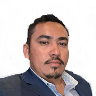 Portrait of a man in a blue suit against a white background.