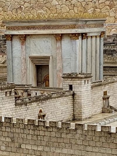 Detailed miniature model of an ancient temple with stone walls.
