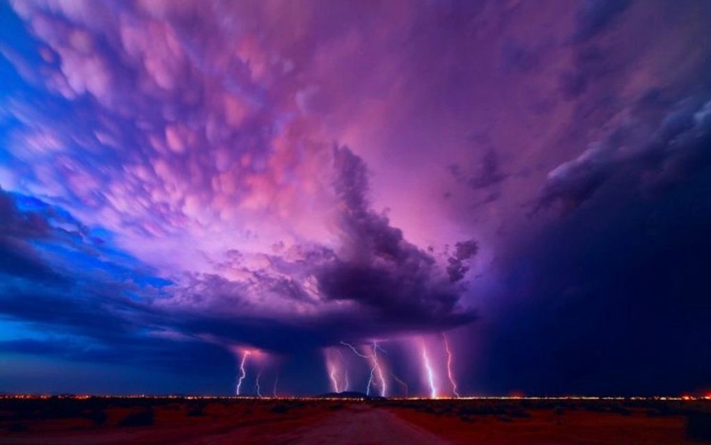 A dramatic lightning storm with purple and blue clouds.