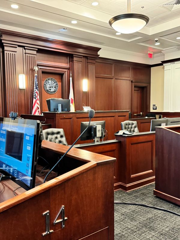Courtroom equipped with monitors, microphones, and trial technology setup for litigation support.

