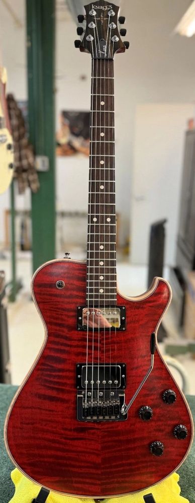 Red electric guitar with a glossy finish and black hardware.