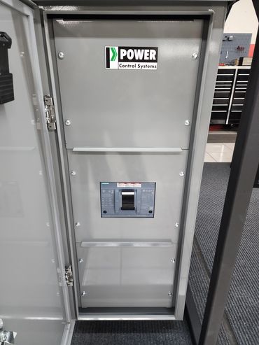 Open electrical control panel with a circuit breaker inside.