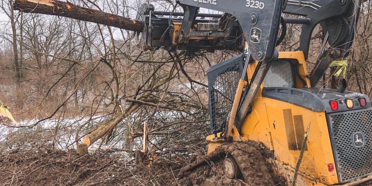 site company solutions working to remove trees and obstacles to install a new septic system for a ne