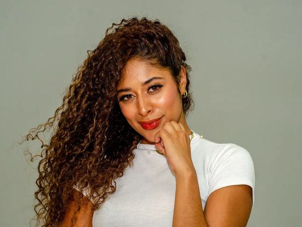 Woman with long, smooth, brown hair flowing in the wind.