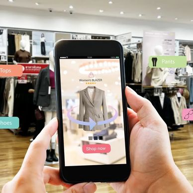 Person using AR app in a clothing store to shop for a women's blazer.