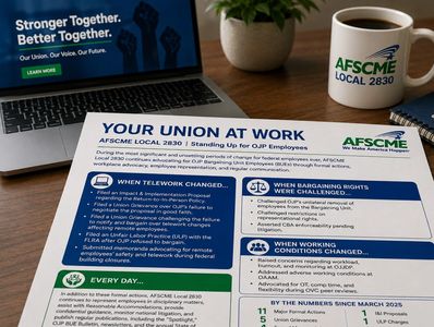 A desk with a laptop, coffee mug, and AFSCME leaflet.