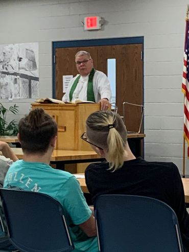 Pastor leading chapel.