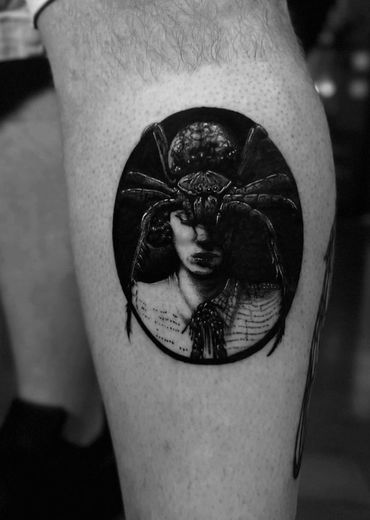 black and gray realism tattoo of a woman with a spider on her head