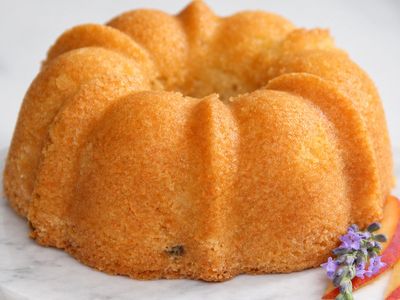 Golden bundt cake on a marble surface.